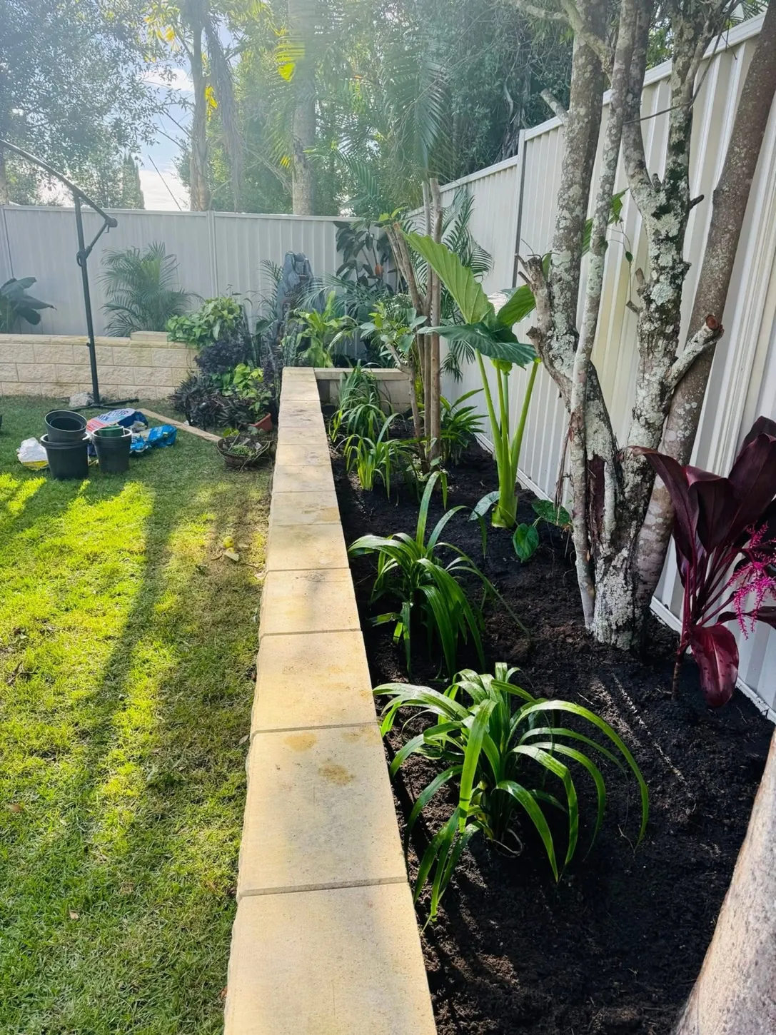 Planted and freshly prepared garden bed at a residential property